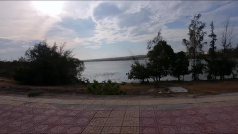 Side POV Driving Shot by Calm Bau Trang Lake with Evening Glow Stock Footage 339989716