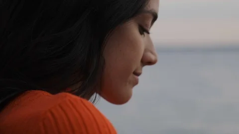 Side profile of beautiful Middle Eastern girl on beach Stock Footage 111977175