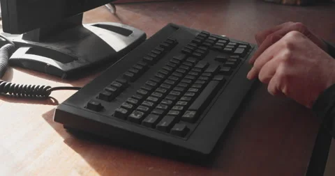 Side profile of beginner learning to type on computer keyboard Stock Footage 332750462