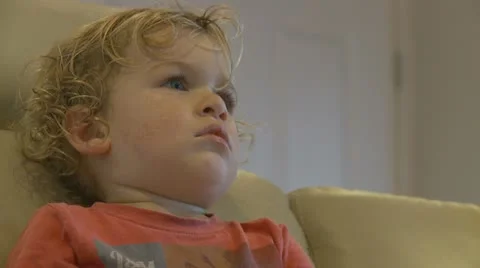 Side profile of boy watching TV mid shot (2) model release Stock Footage 22029629
