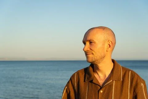 Side Profile of a Calm Man Looking at Sea After Hair Transplant Stock Photos