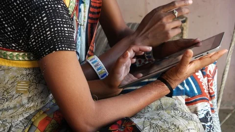 Side profile close up tilt up hands fingers using pad ladies working and discuss Stock Footage 92839156
