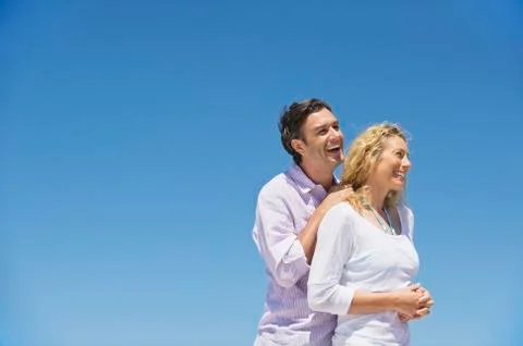 Side profile of a couple smiling Stock Photos
