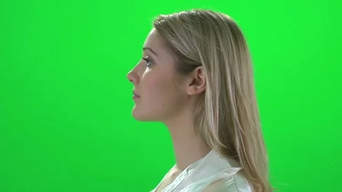 Side profile face view of young blond women isolated on greenscreen Stockbeeldmateriaal 72873634