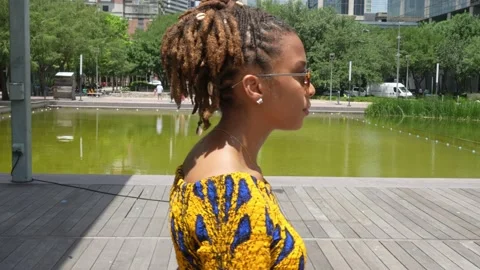 Side Profile of female model walking across a bridge Stock Footage 196358693