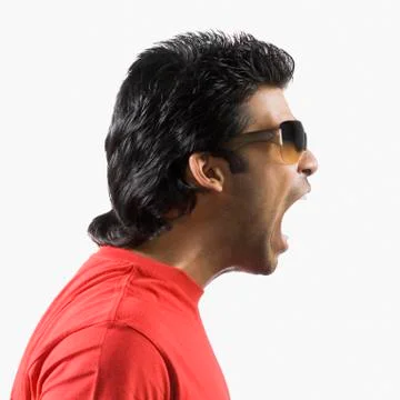 Side profile of a man shouting Stock Photos