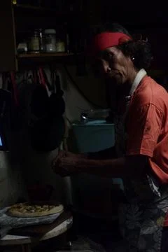 Side Profile of Man Working in Dim Kitchen Stock Photos