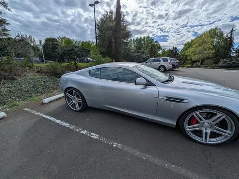 Side profile of a pristine silver Aston Martin DB9 Coupe Stock Photos
