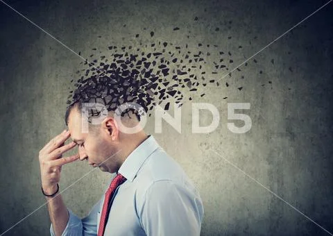 Side profile of a sad man losing parts of head as symbol of decreased mind fu Stock Photos