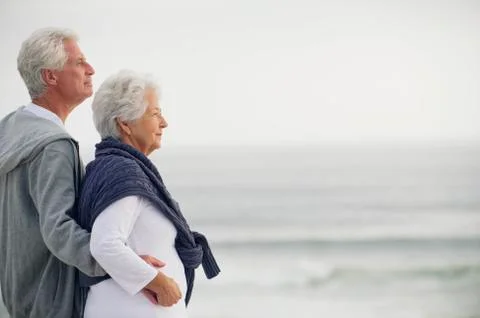 Side profile of a senior couple looking at the sea Stock Photos