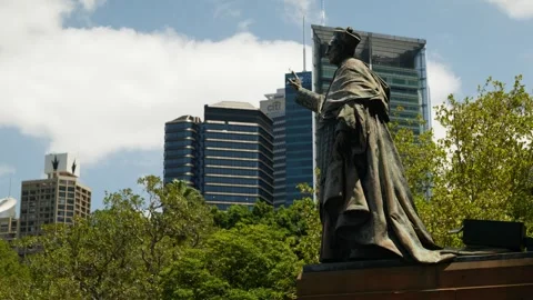 Side profile statue of Gardinal Patrick Moran and Sydney skyscrapers 6K Stock Footage 300739808