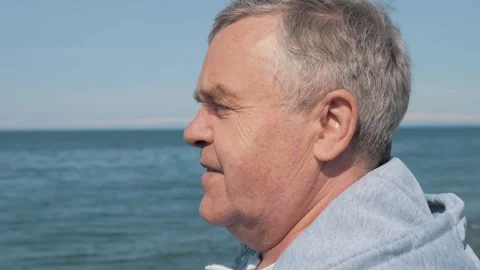 Side profile of thoughtful senior man gazing at sea Stock Footage 268012794