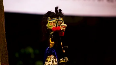 Side profile view of red faced ogre wayang golek puppet character on stage .. Stock Footage 344792567