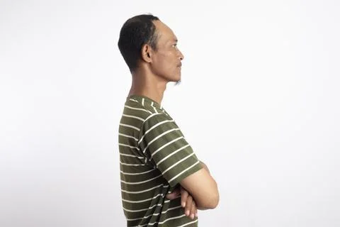 Side profile view of a smiling young Asian man, wearing a casual green t-sh.. Stock Photos