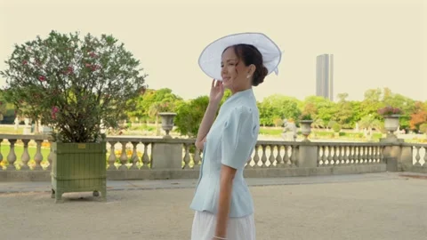 Side Profile of Woman Walking Through Luxembourg Gardens Stock Footage 344960178