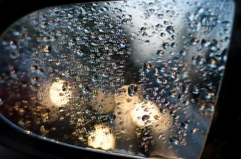 Side rear-view mirror in the evening on the road during sunset Stock Photos