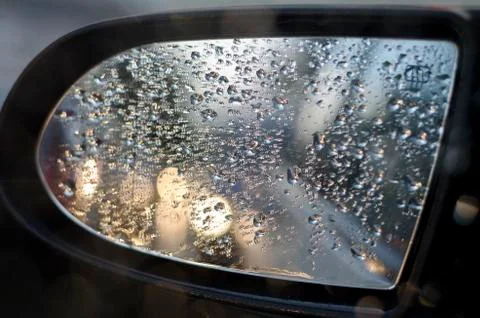Side rear-view mirror in the evening on the road during sunset Stock Photos