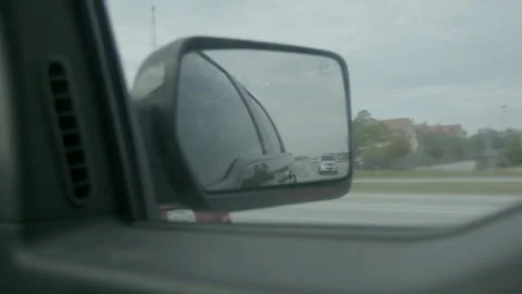 Side Rearview Mirror View of Highway Traffic Stock Footage 343881192