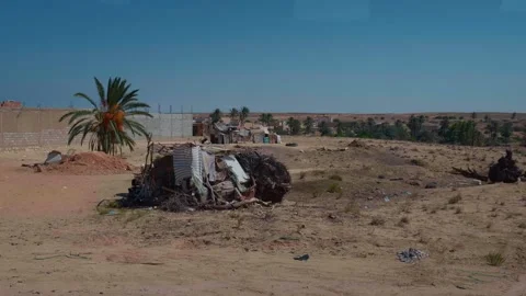 Side road view of unfinished constructions and outdoor settlements. Stock Footage 296377012