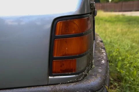 Side of rusty headlight of an 80's car. Stock Photos