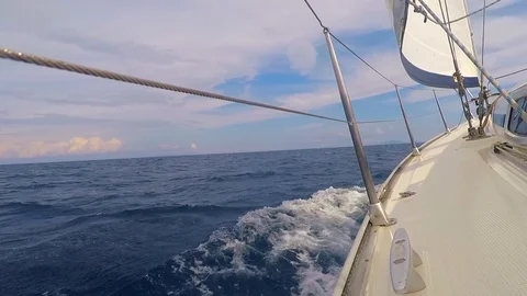 Side of a sailboat open sails in the sea waves Stock Footage 112604230