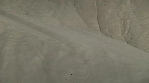 Side scraper reclaimer. Mountains of white sand in the hangar. Stock Footage 95975268