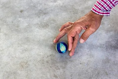 Side shoot of old man plays traditional turkish game on concrete Stock Photos