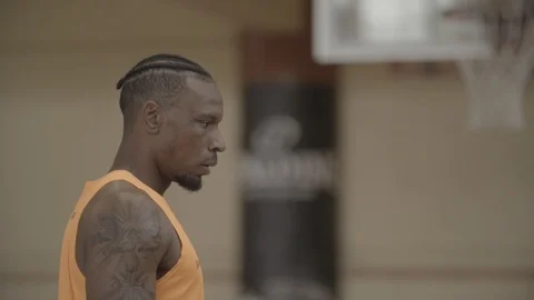SIDE SHOT OF BLACK MAN SHOOTING BALL BASKETBALL INDOOR PRACTICE SLOW MOTION Video stock 99921844