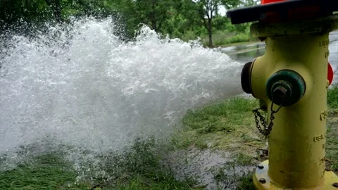 Side shot of fire hydrant spraying water on open road. Stock Footage 139669508