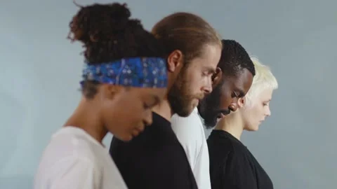Side shot of group of people of different races raise head black white man woman Stock Footage 133641037