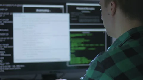 Side shot of hacker using malware to infiltrate into protected servers Stock Footage 142988459