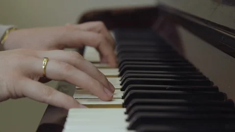 SIDE ON SHOT OF HANDS PLAYING UPRIGHT PIANO Stock Footage 126418359