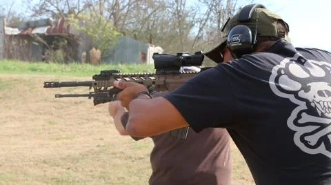 Side Shot of Man Shooting AR-15 Assault Rifle at Outdoor Target Stock Footage 58578797