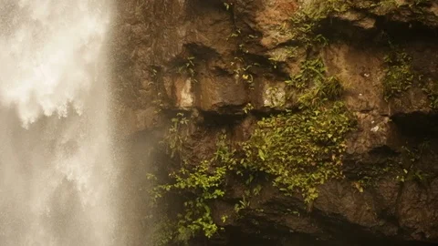 Side shot of powerful waterfall streaming past rock face Stock Footage 107653989