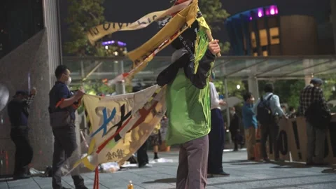 Side shot of protestors demonstrating against the 2020 Tokyo Olympics - 4K Stock Footage 154897969