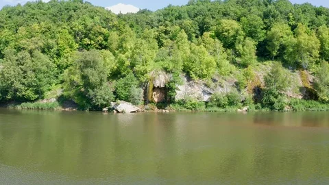Side shot of a steep river slope where a small waterfall is located. Stock Footage 119075894