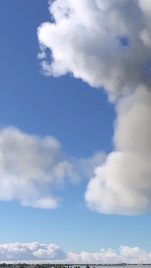 Side shot of a windmill and nuclear power plant in Doel. Belgium Video stock 283420599