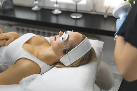 Side-shot of a woman's face being prepared for a ThermoLift facial treatment Stock Photos