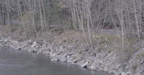 Side by Side 4x4 Driving along gravel road Aerial Drone over river through trees Stock Footage 144778769