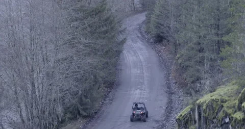 Side by Side 4x4 Vehicle Driving gravel road Aerial drone Stock Footage 144780076