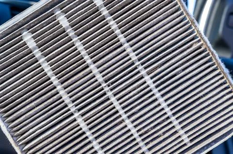 Side-by-side comparison of a dirty and clean automotive cabin filter Stock Photos