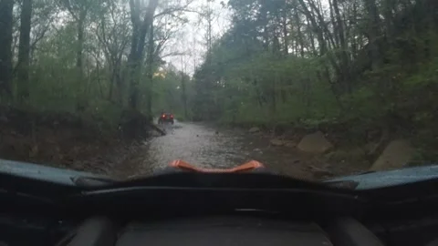 Side by side following another side by side down a stream bed, wet and wild fun Stockbeeldmateriaal 334100932
