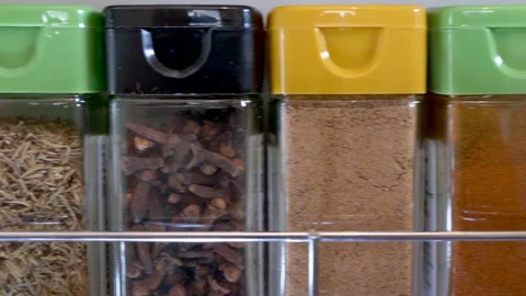 Side-by-side range of cooking herbs and spices in jars. Stock Footage 200873510