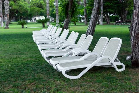 Side by side rows of white sun loungers Stock Photos