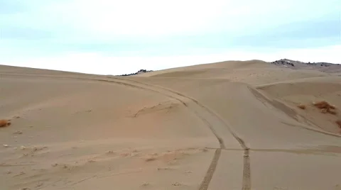 Side by side sport vehicle races up a sand dune Stock Footage 59171542