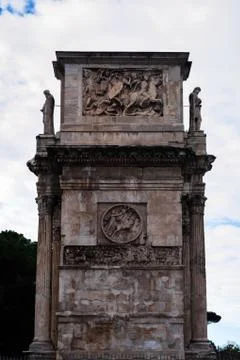 Side slice of the Arch of Contantine next to the Colosseum in Rome Stock Photos