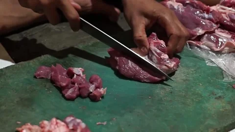 From the side, slice the beef into small pieces for beef satay Stock Footage 273040539