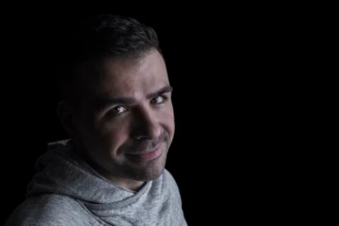 Side studio portrait of a caucasian man looking at the camera. Stock Photos