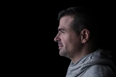 Side studio portrait of a serious man looking sideways. Stock Photos