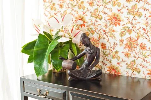 Side table with flowers and interior decoration Stock Photos